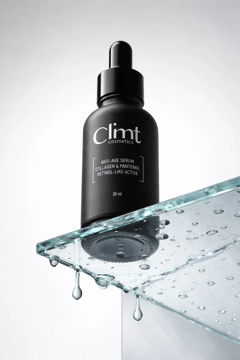 A dark cosmetic dropper bottle with reflective glass, sharp edges, and visible surface texture.